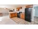 Open kitchen with wood cabinets, black appliances, and an adjacent dining area at 977 Forest Knoll Ct, Lithia Springs, GA 30122
