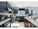 Contemporary kitchen with dark cabinetry, a stylish backsplash, and plenty of counter space for cooking at 977 Forest Knoll Ct, Lithia Springs, GA 30122