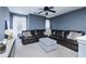 Comfortable living room features a large sectional sofa, ottoman, and plenty of space at 977 Forest Knoll Ct, Lithia Springs, GA 30122
