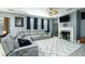 Cozy living room featuring a fireplace, comfortable seating, and a ceiling fan for added comfort at 977 Forest Knoll Ct, Lithia Springs, GA 30122