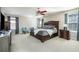 Spacious main bedroom with a king bed, ceiling fan, and carpeted floors at 977 Forest Knoll Ct, Lithia Springs, GA 30122