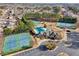 A picturesque aerial view of community amenities including tennis courts, swimming pool, and clubhouse at 2143 Great Shoals Cir, Lawrenceville, GA 30045