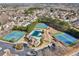 An aerial shot highlighting community amenities with tennis courts, a pool, clubhouse and playground at 2143 Great Shoals Cir, Lawrenceville, GA 30045