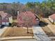 Overhead view of a brick home with mature trees and professional landscaping, nestled in a suburban neighborhood at 2143 Great Shoals Cir, Lawrenceville, GA 30045