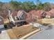 Aerial view showcasing the home's landscaped yard, two-car garage, and desirable neighborhood setting at 2143 Great Shoals Cir, Lawrenceville, GA 30045