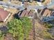 An aerial view of a home with backyard, featuring lush greenery and mature trees at 2143 Great Shoals Cir, Lawrenceville, GA 30045