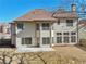 Rear exterior of home with large windows offering natural light and a small patio area at 2143 Great Shoals Cir, Lawrenceville, GA 30045