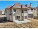 Back exterior view of a two-story home showing a new concrete patio and fenced yard at 2143 Great Shoals Cir, Lawrenceville, GA 30045