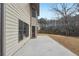 Side view of house showing patio and fenced backyard with natural surroundings at 2143 Great Shoals Cir, Lawrenceville, GA 30045