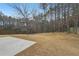Expansive backyard featuring a privacy fence and mature trees and a patio area at 2143 Great Shoals Cir, Lawrenceville, GA 30045