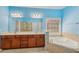 Bright bathroom with a large mirror, dual sinks, soaking tub, and walk-in shower at 2143 Great Shoals Cir, Lawrenceville, GA 30045