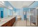 This bathroom features dual sinks, a glass-enclosed shower, and a large soaking tub at 2143 Great Shoals Cir, Lawrenceville, GA 30045