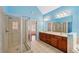 Light-filled bathroom featuring a double vanity, glass shower, and neutral tile at 2143 Great Shoals Cir, Lawrenceville, GA 30045