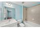 Bathroom featuring single sink vanity, toilet, and shower-tub combo with tiled walls at 2143 Great Shoals Cir, Lawrenceville, GA 30045