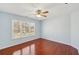 Bright bedroom with wood floors and a large window overlooking the front yard at 2143 Great Shoals Cir, Lawrenceville, GA 30045