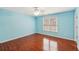 Cozy bedroom featuring a ceiling fan, hardwood floors, and plenty of natural light from the window at 2143 Great Shoals Cir, Lawrenceville, GA 30045