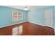 Spacious primary bedroom with natural light, ceiling fan and hardwood flooring at 2143 Great Shoals Cir, Lawrenceville, GA 30045