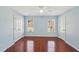 Bedroom featuring laminate floors and two windows at 2143 Great Shoals Cir, Lawrenceville, GA 30045