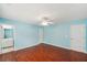 Bedroom with natural light, view into bathroom, ceiling fan and hardwood flooring at 2143 Great Shoals Cir, Lawrenceville, GA 30045