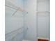 Walk in closet with hanging metal racks and hardwood flooring at 2143 Great Shoals Cir, Lawrenceville, GA 30045