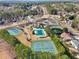 Aerial view of community amenities including tennis courts and a sparkling swimming pool at 2143 Great Shoals Cir, Lawrenceville, GA 30045