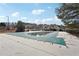 Well-maintained community pool with a partial pool cover, with a clubhouse in the background at 2143 Great Shoals Cir, Lawrenceville, GA 30045