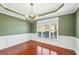 Dining room featuring a decorative chandelier, natural lighting, and wainscoting at 2143 Great Shoals Cir, Lawrenceville, GA 30045