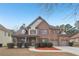 Stunning brick home with well-manicured landscaping and a two-car garage at 2143 Great Shoals Cir, Lawrenceville, GA 30045