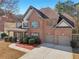 Traditional brick home with two-car garage, mature landscaping, and inviting front porch at 2143 Great Shoals Cir, Lawrenceville, GA 30045