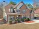 Stately brick home boasts a two-car garage, manicured lawn, and classic architectural details at 2143 Great Shoals Cir, Lawrenceville, GA 30045