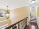 Upstairs hallway with hardwood floors, a decorative light fixture, and natural light at 2143 Great Shoals Cir, Lawrenceville, GA 30045