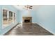 Living room with stone fireplace, ceiling fan, and natural light from many windows at 2143 Great Shoals Cir, Lawrenceville, GA 30045