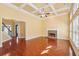 Open living room with fireplace, coffered ceilings, and hardwood floors at 2143 Great Shoals Cir, Lawrenceville, GA 30045