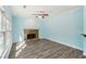 Living room with stone fireplace, ceiling fan, and natural light from many windows at 2143 Great Shoals Cir, Lawrenceville, GA 30045