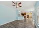 Open living area featuring a ceiling fan, wood floors, and a view into the kitchen at 2143 Great Shoals Cir, Lawrenceville, GA 30045