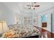 Spacious bedroom boasts tray ceilings, recessed lighting, a ceiling fan, and access to the ensuite bathroom at 2143 Great Shoals Cir, Lawrenceville, GA 30045