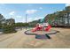 Community playground with slides and climbing structures, surrounded by trees and green space at 2143 Great Shoals Cir, Lawrenceville, GA 30045