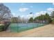 Outdoor tennis courts with manicured landscaping and lighting for evening play at 2143 Great Shoals Cir, Lawrenceville, GA 30045