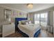 Bright bedroom with plush blue headboard, crystal chandelier, and large window at 2657 Lenox Rd # C30, Atlanta, GA 30324