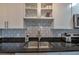 Modern kitchen with stainless steel sink, granite countertops, and diamond patterned backsplash at 2657 Lenox Rd # C30, Atlanta, GA 30324