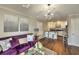Cozy living room flows into kitchen with breakfast bar, modern lighting, and hardwood floors at 2657 Lenox Rd # C30, Atlanta, GA 30324