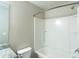 Bright bathroom with a white shower-tub combination, toilet, and granite countertop vanity at 3293 Pennington Dr, Stonecrest, GA 30038