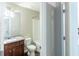 Well-lit bathroom with a granite countertop vanity, mirror, toilet, and shower-tub combo at 3293 Pennington Dr, Stonecrest, GA 30038