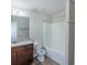 Bright bathroom with a white shower-tub combination, toilet, and granite countertop vanity at 3293 Pennington Dr, Stonecrest, GA 30038