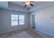 Neutral bedroom featuring carpet, a ceiling fan, and a window providing natural light at 3293 Pennington Dr, Stonecrest, GA 30038