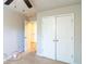 Bedroom featuring carpeted floors, a ceiling fan, and a closet with double doors at 3293 Pennington Dr, Stonecrest, GA 30038