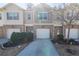 Charming townhome featuring a brick facade, an attached garage, and a well-manicured front yard at 3293 Pennington Dr, Stonecrest, GA 30038