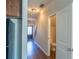 Hallway with hardwood floors, a staircase, and a view of the half bath at 3293 Pennington Dr, Stonecrest, GA 30038