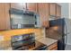 Close up view of the kitchen showcasing stainless steel appliances, granite countertops, and tile backsplash at 3293 Pennington Dr, Stonecrest, GA 30038