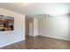 Open-concept living room with hardwood floors that transitions into the kitchen area with dark cabinets at 3293 Pennington Dr, Stonecrest, GA 30038